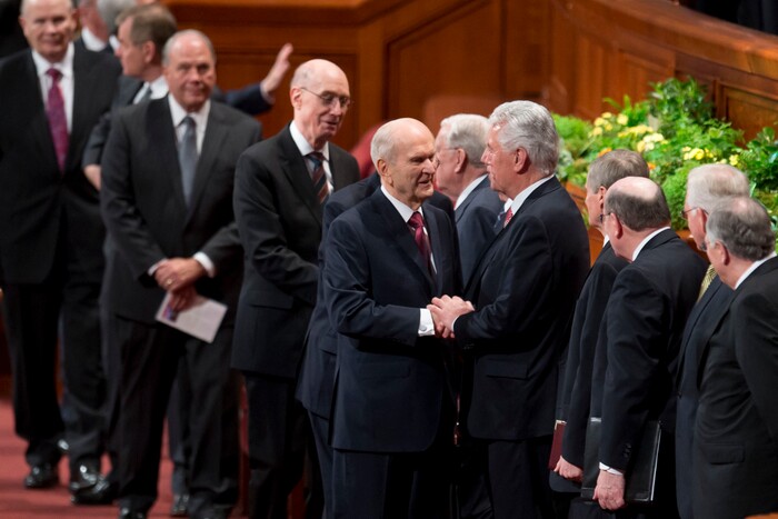 (Jeremy Harmon  |  The Salt Lake Tribune) President Russell M. Nelson shakes hands with Elder Dieter F. Uchtdorf at the end of the Sunday morning session of General Conference on April 1, 2018.