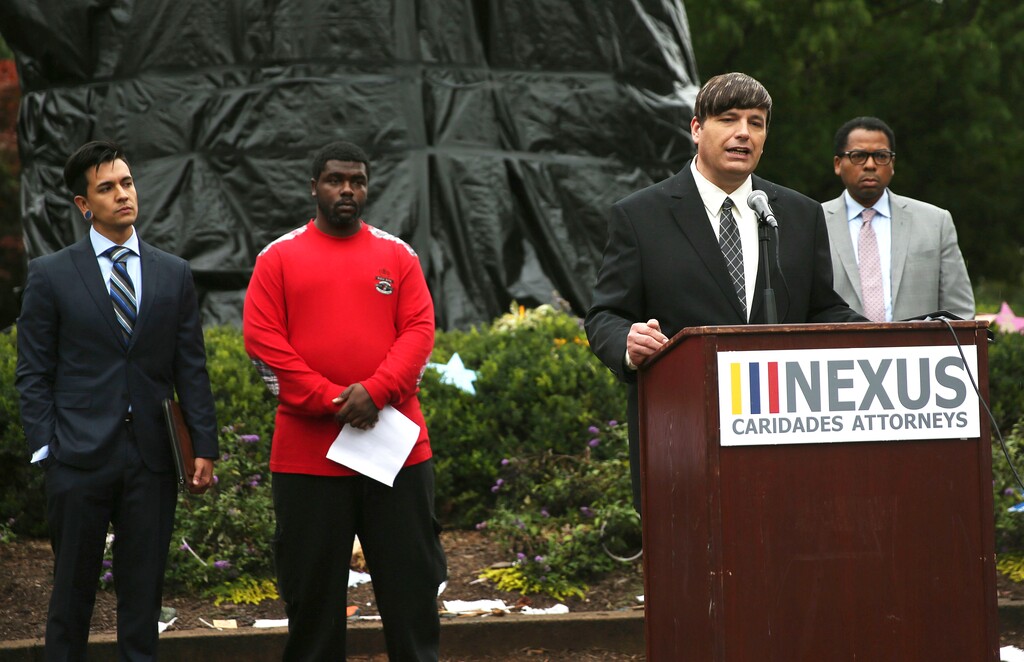 Mike Donovan, President and CEO of Nexus Services, Inc., speaks during a news conference in Emancipation Park in Charlottesville, Va., on Friday, Sept. 1, 2017, to announce a suit against the city on behalf of Robert Turner, second left, over their response to a white nationalist rally that descended into violence on Aug. 12.  (Zack Wajsgras/The Daily Progress via AP)