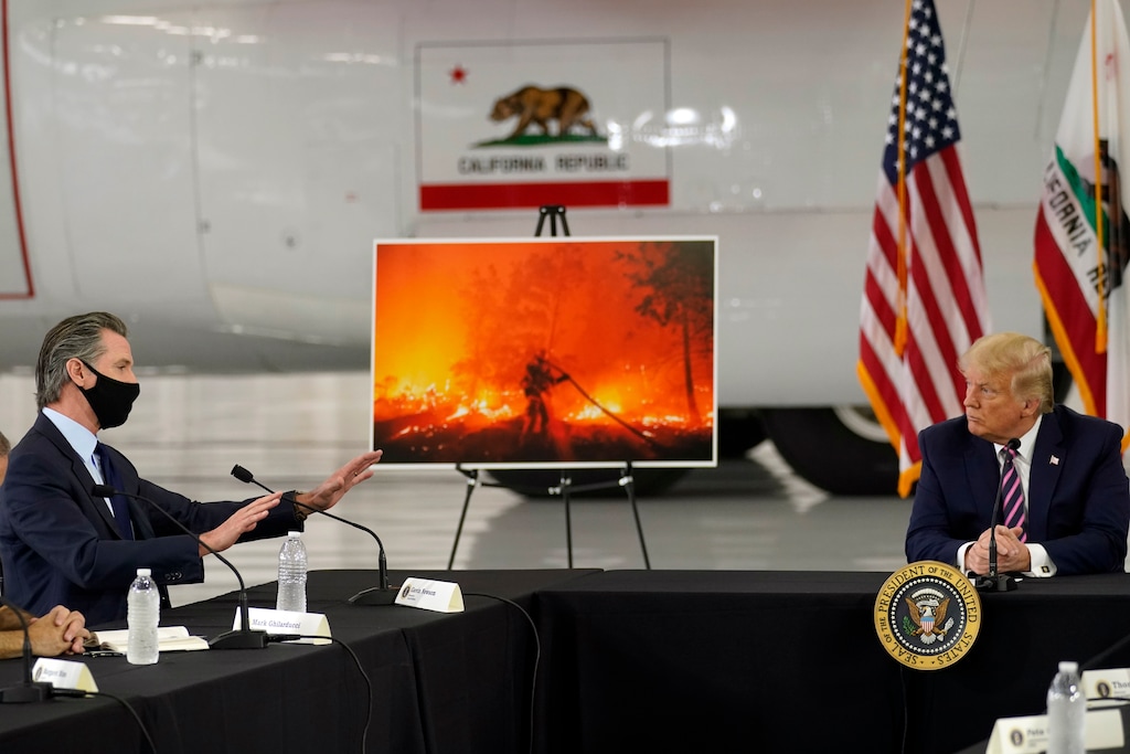 President Donald Trump listens as California Gov. Gavin Newsom speaks during a briefing at Sacramento McClellan Airport, in McClellan Park, Calif., Monday, Sept. 14, 2020, on the western wildfires. (AP Photo/Andrew Harnik)