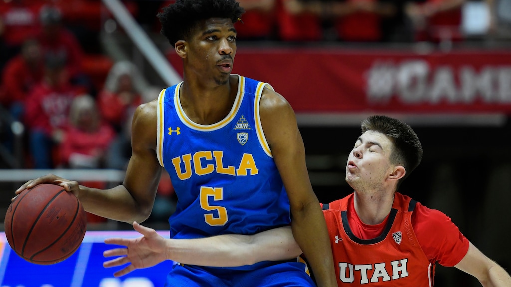 UCLA guard Chris Smith (5) attempts to dribble around Utah guard Rylan Jones (15) during the first half of an NCAA college basketball game Thursday, Feb. 20, 2020, in Salt Lake City. (AP Photo/Alex Goodlett)