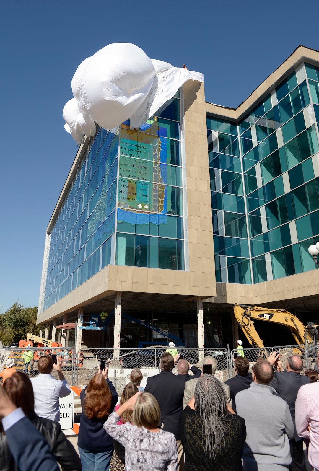 (Al Hartmann  |  The Salt Lake Tribune) 	Crowd gathers for the unveiling of the new glass art covering the façade of the downtown District Attorney building at 35 E. 500 S. in Salt Lake City September 27, 2017.   The glass artwork is complete, but the building is currently under construction to be completed in Spring 2018.  