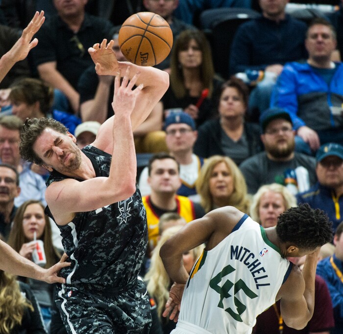 (Rick Egan  |  The Salt Lake Tribune)   San Antonio Spurs center Pau Gasol (16) loses control of the ball, as he collides with Utah Jazz guard Donovan Mitchell (45), in NBA action, in Salt Lake City, Monday, February 12, 2018.