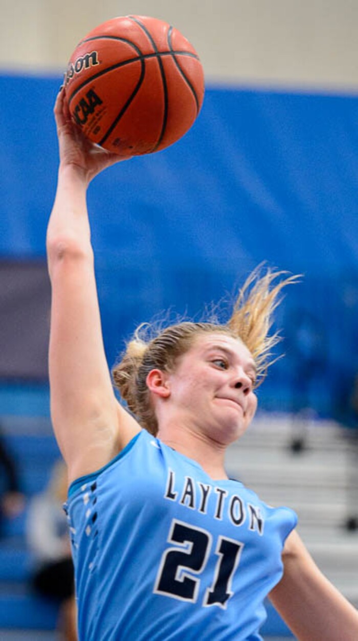 (Trent Nelson | The Salt Lake Tribune)  Layton's Gracey Criswell (21) reaches for a rebound as Layton faces Copper Hills in the 6A High School Girls' Basketball Tournament at SLCC in Taylorsville, Thursday Feb. 22, 2018.