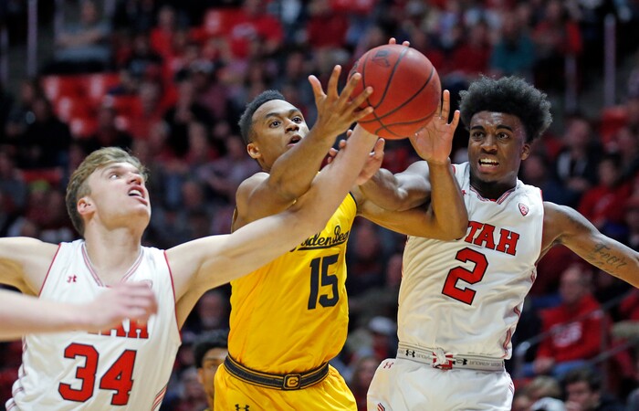 Utah's Jayce Johnson (34) and Kolbe Caldwell (2) reach for a rebound against California forward Roman Davis (15) during the first half of an NCAA college basketball game Saturday, Feb. 10, 2018, in Salt Lake City. (AP Photo/Rick Bowmer)