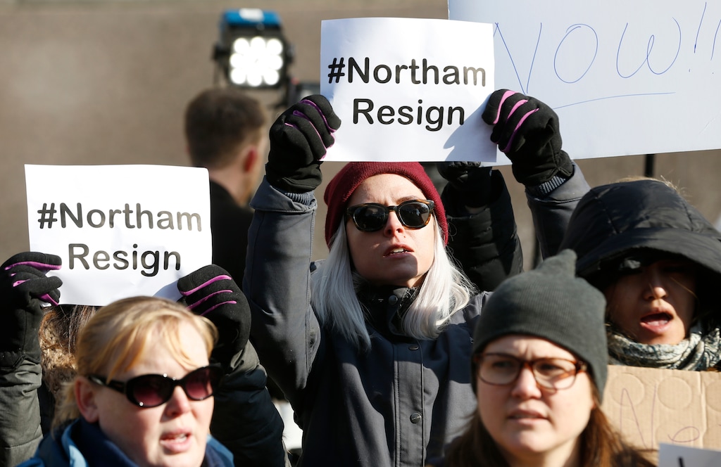 (AP Photo/Steve Helber) Demonstrators hold signs and chant outside the Governors Mansion at the Capitol in Richmond, Va., Saturday, Feb. 2, 2019. The demonstrators are calling for the resignation of Virginia Governor Ralph Northam after a 30 year old photo of him on his medical school yearbook photo was widely distributed Friday.