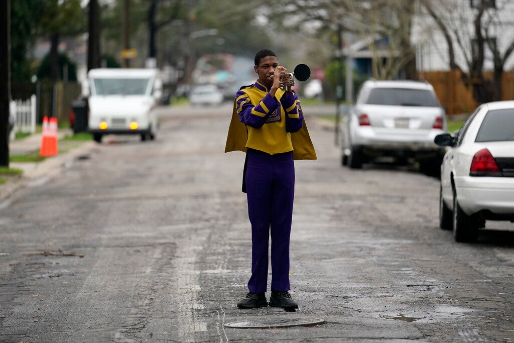 Elvin King III a senior at Warren Easton High and member of their marching band, poses for a portrait in front of his home in New Orleans, Friday, Feb. 12, 2021. (AP Photo/Gerald Herbert)