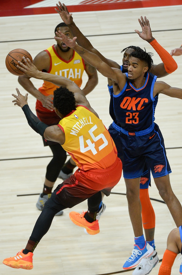 (Francisco Kjolseth  |  The Salt Lake Tribune)   Utah Jazz guard Donovan Mitchell (45) pushes past Oklahoma City Thunder guard Terrance Ferguson (23) as he battles the Thunder in the NBA game at Vivint Smart Home Arena Sat., Dec. 22, 2018, in Salt Lake City.