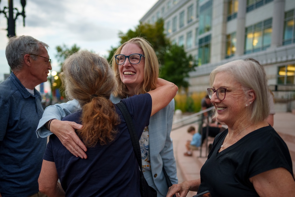 (Trent Nelson | The Salt Lake Tribune) Emma Petty Addams, of Mormon Women for Ethical Government, embraces other activists at a news conference in Salt Lake City on Monday, Aug. 25, 2025. A judge earlier ruled that the Legislature will have 30 days to adopt new maps that comply with the 2018 Better Boundaries initiative guidelines. At right is Katharine Biele, of League of Women Voters of Utah.