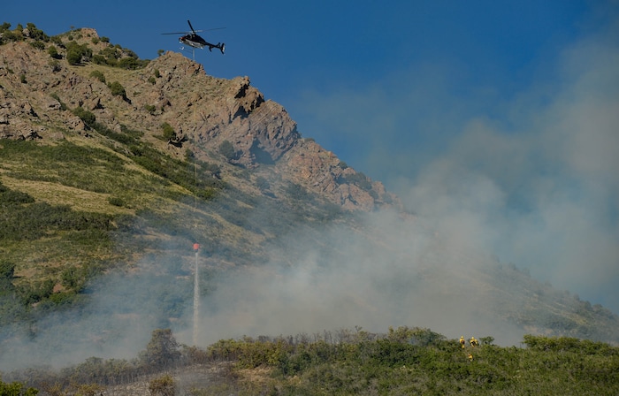 (Francisco Kjolseth  |  The Salt Lake Tribune) Fire crews battle a fire near Millcreek Canyon, on Saturday, July 11, 2020, started near 3400 South Crestwood Dr., as helicopters, single engine air tankers and multiple crews respond.