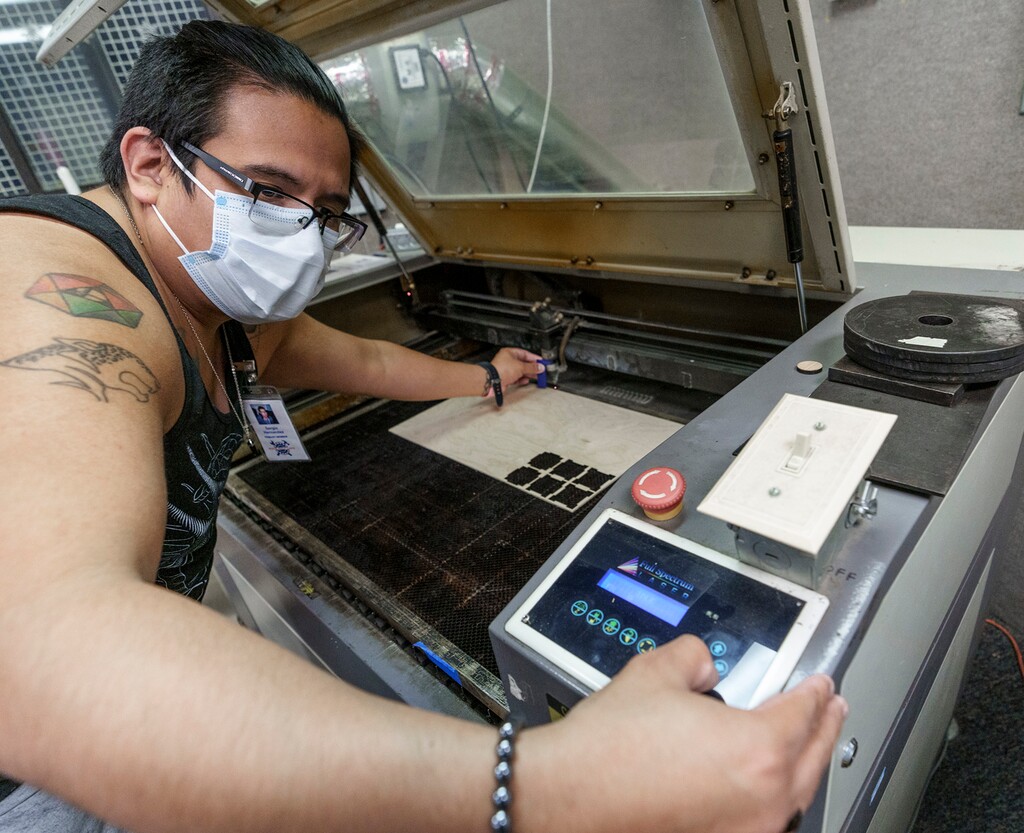 (Leah Hogsten | The Salt Lake Tribune) Sergio Hernandez, a volunteer instructor at Make Salt Lake, calibrates the laser wood cutting machine, Dec. 7, 2022. Make Salt Lake is a "makerspace" that provides access to tools, machinery and space for their members to make art and projects.