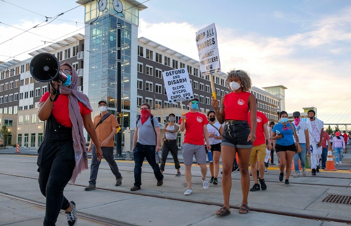 (Leah Hogsten  |  The Salt Lake Tribune) Protesters walk from the West Valley Police Department during the People's Council rally to defund the police force, Aug.8, 2020.  Saturday's rally was hosted by the Salt Lake chapter of the Party for Socialism and Liberation.