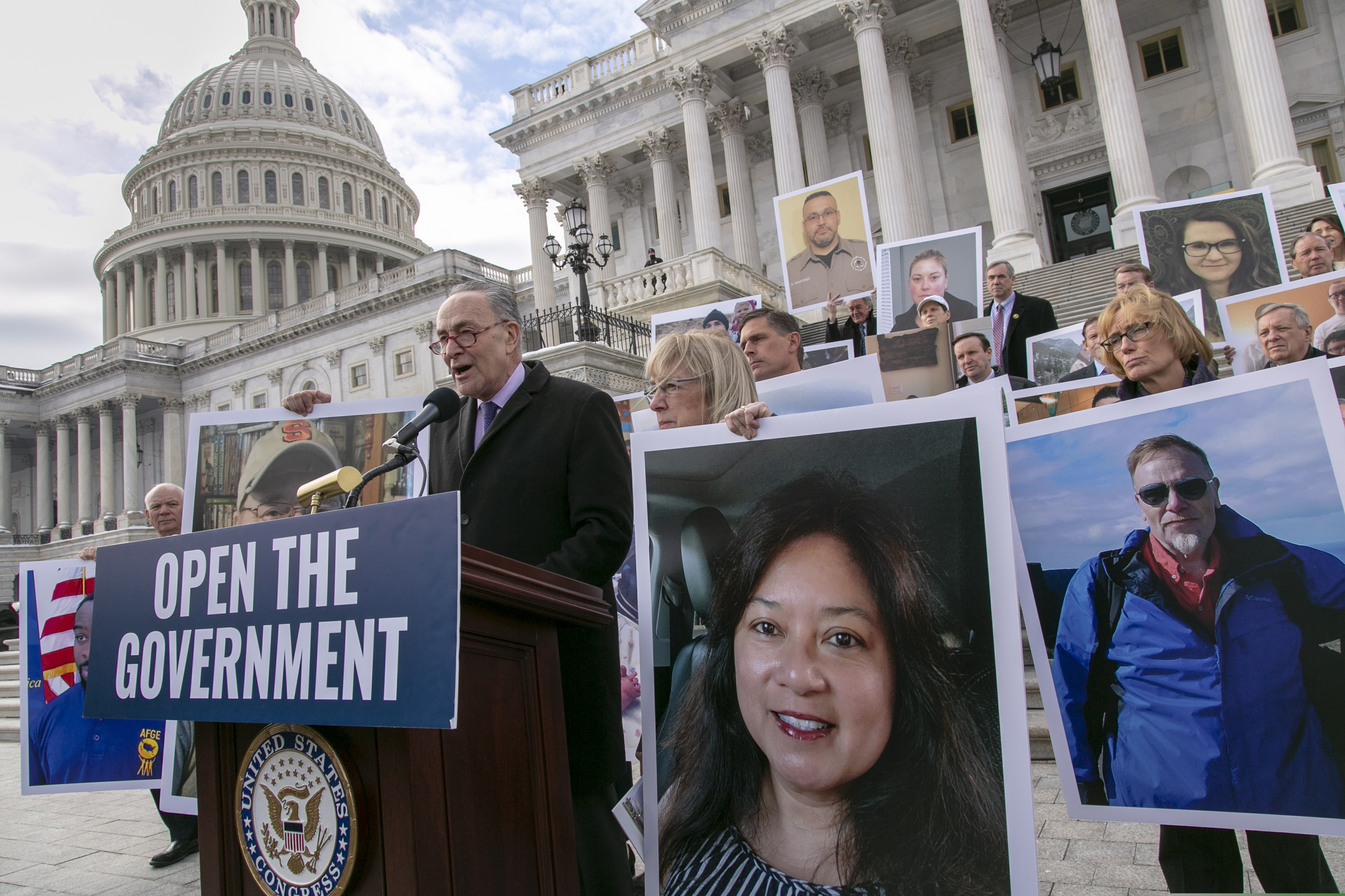 (J. Scott Applewhite | The Associated Press) On day 26 of the partial government shutdown, Senate Democrats, led by Senate Minority Leader Chuck Schumer, D-N.Y., and Senate Health, Education, Labor and Pensions ranking member Patty Murray, D-Wash., assemble outside the Capitol holding photographs of their constituents affected by the impasse between Congress and the White House, in Washington, Wednesday, Jan. 16, 2019.
