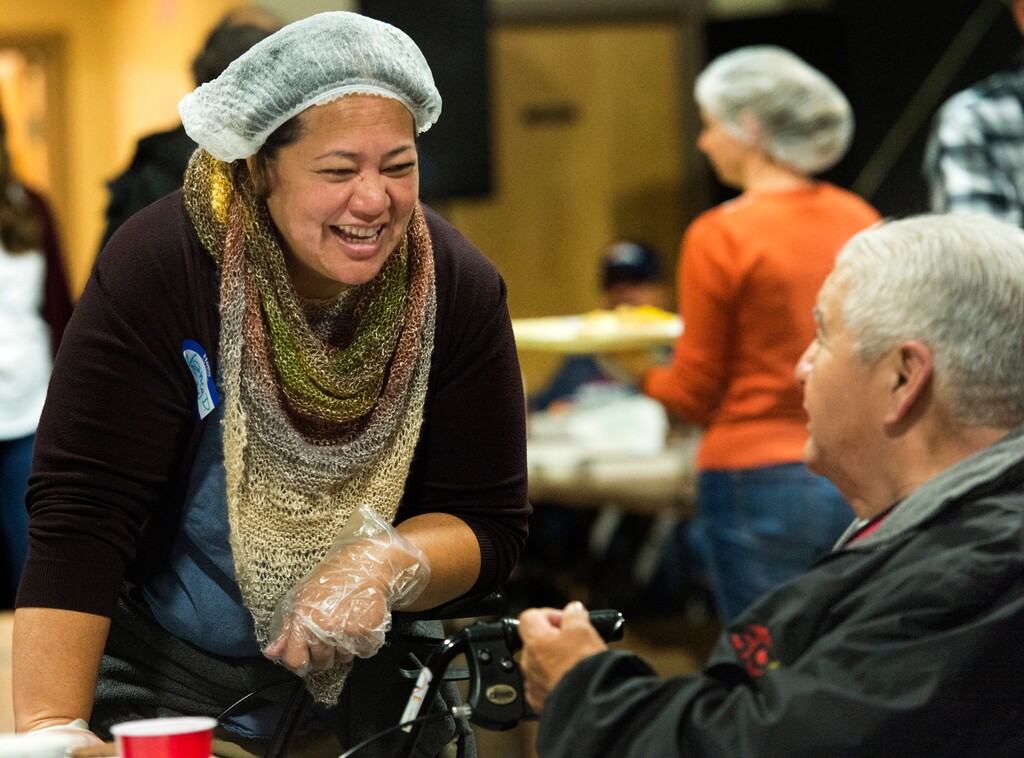 (Rick Egan  |  Tribune file photo) Volunteer, Nancy Drozeek visits with fellow Hawaiian, Jeremiah  Kahananui at the 25th annual Thanksgiving Dinner for the hungry and homeless, at the Christian Life Center, on Redwood Road in Salt Lake City, Wednesday, Nov. 21, 2018.