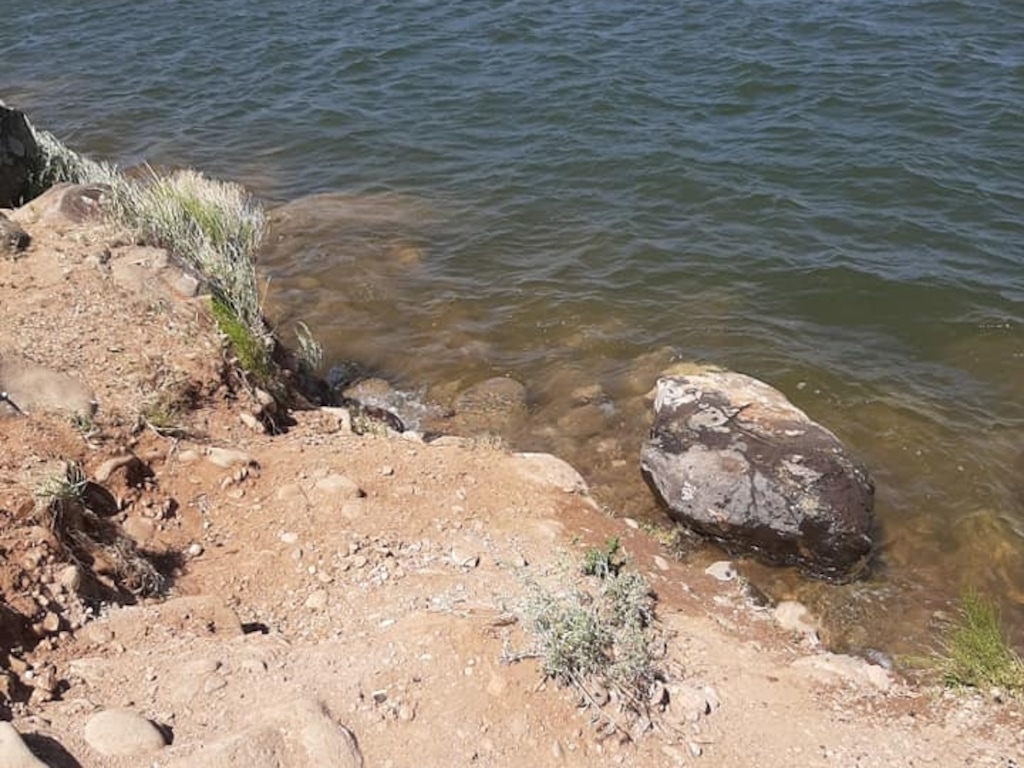 (Photo courtesy of Jen Beard) A boulder hosting a historic petroglyph sits overturned in the water near Gunlock State Parking in Washington County on May 7, 2020.