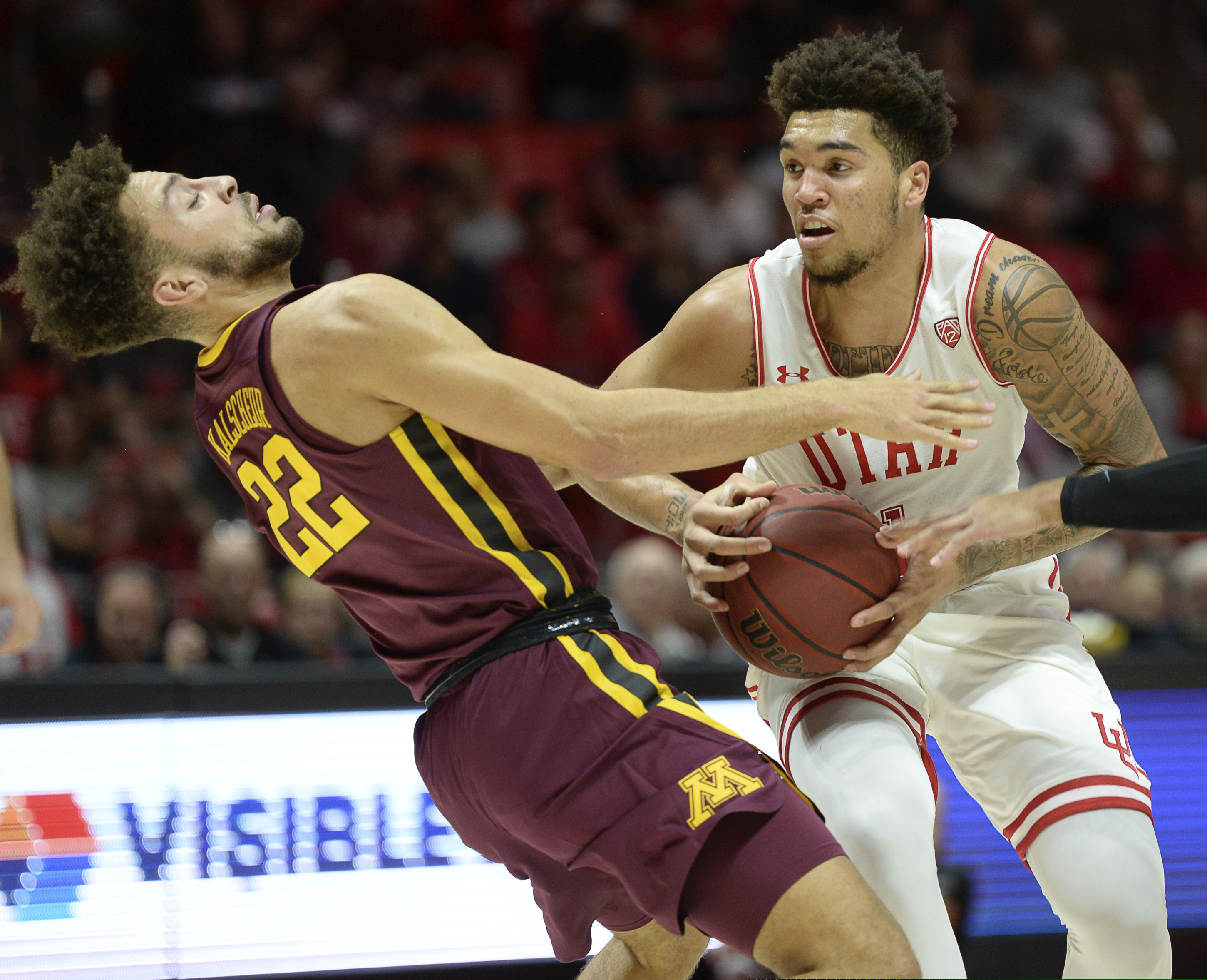 (Francisco Kjolseth | Tribune file photo) Utah forward Timmy Allen drives into Minnesota guard Gabe Kalscheur (22) during the Utes' 73-69 victory Nov. 15, 2019.