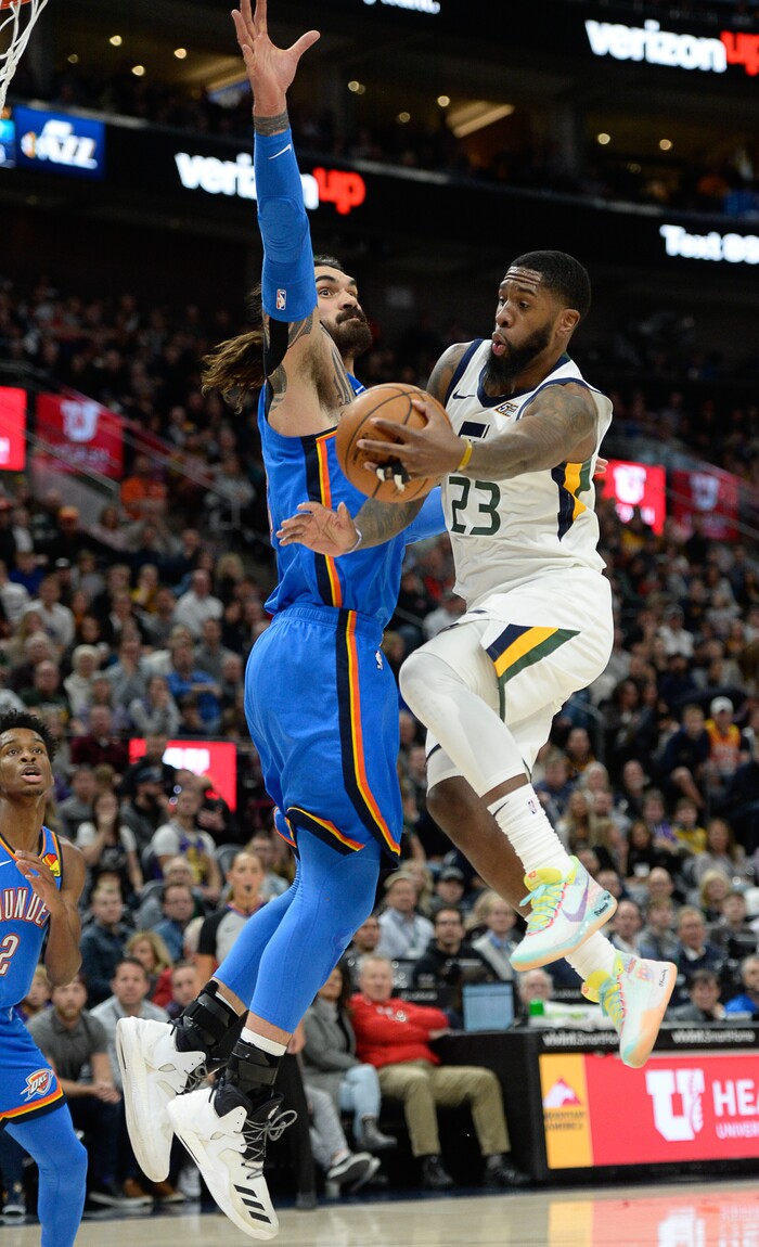 (Francisco Kjolseth  |  The Salt Lake Tribune)  Utah Jazz forward Royce O'Neale (23) is pressured by Oklahoma City Thunder center Steven Adams (12) as the Utah Jazz host the Oklahoma City Thunder in their NBA basketball game at Vivint Smart Home Arena in Salt Lake City on Mon. Dec. 9, 2019.
