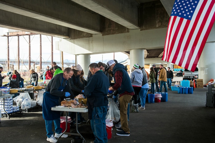 (Chris Detrick | The Salt Lake Tribune) Volunteers prepare Thanksgiving Day meals during the Eagle Ranch Chuckwagon under the viaduct at 500 South and 600 West in Salt Lake City Thursday, November 23, 2017.