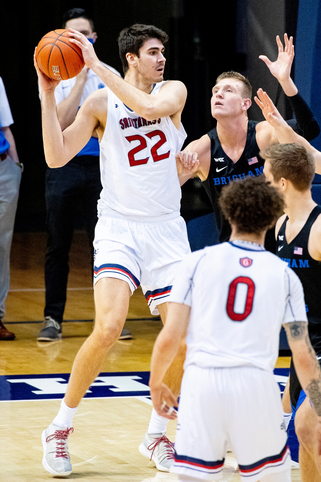 (Isaac Hale | Special to The Tribune) St. Mary's College center Matt Van Komen (22) looks to pass the ball out while guarded by Brigham Young University forward Kolby Lee (40) during a game between the BYU Cougars and the Saint Mary’s College of California Gaels held at the Marriott Center in Provo on Saturday, Feb. 27, 2021.