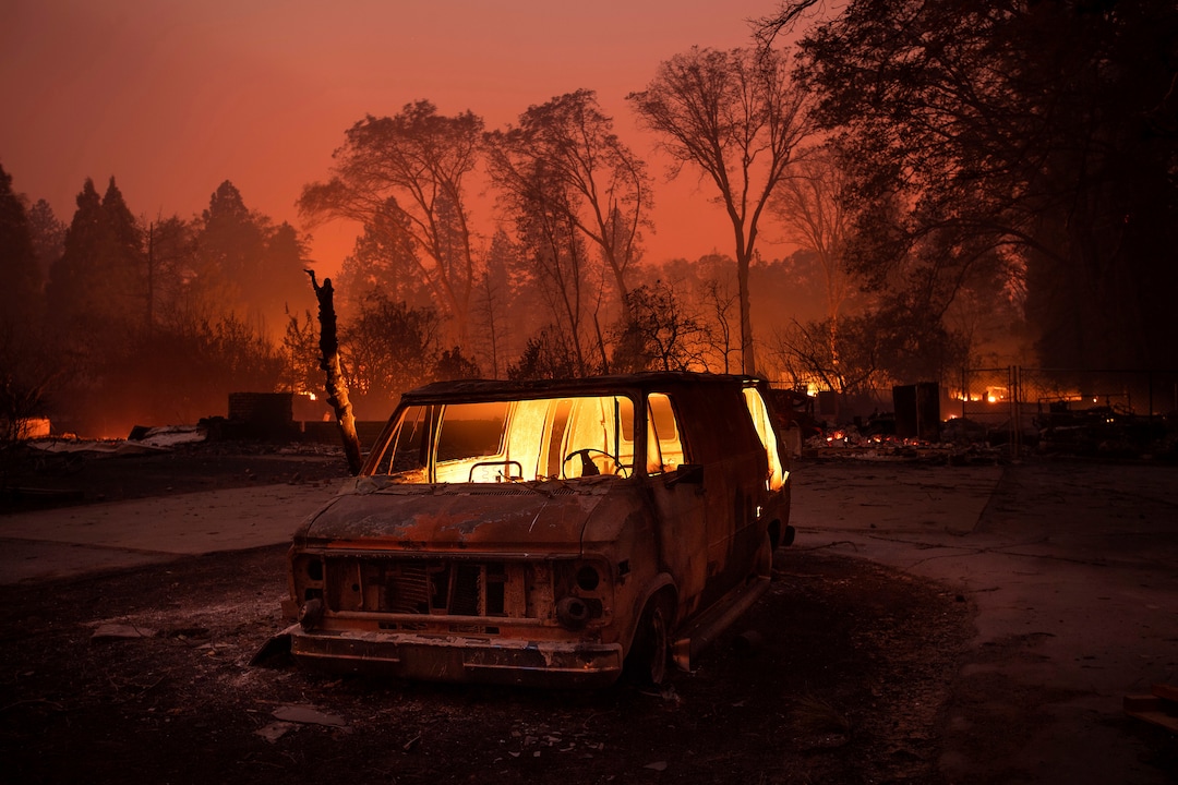 (Noah Berger | The Associated Press) Flames burn inside a van as the Camp Fire tears through Paradise, Calif., on Thursday, Nov. 8, 2018. Tens of thousands of people fled a fast-moving wildfire Thursday in Northern California, some clutching babies and pets as they abandoned vehicles and struck out on foot ahead of the flames that forced the evacuation of an entire town and destroyed hundreds of structures.