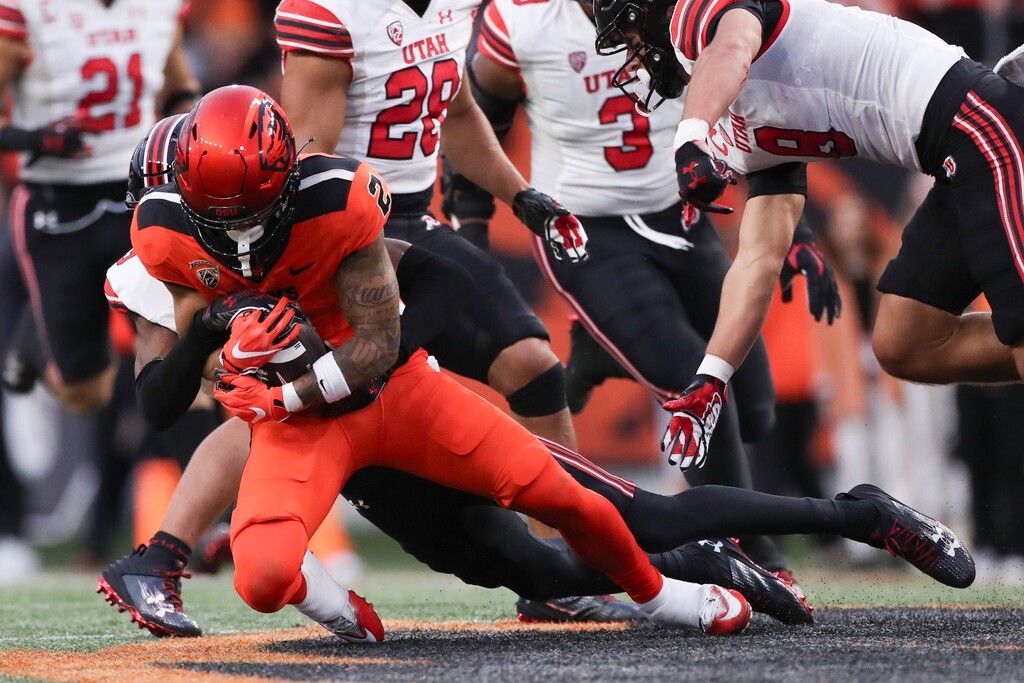 (Amanda Loman | AP) Oregon State wide receiver Anthony Gould (2) is brought down by Utah cornerback Zemaiah Vaughn, back, during the first half of game on Sept. 29, in Corvallis, Ore.