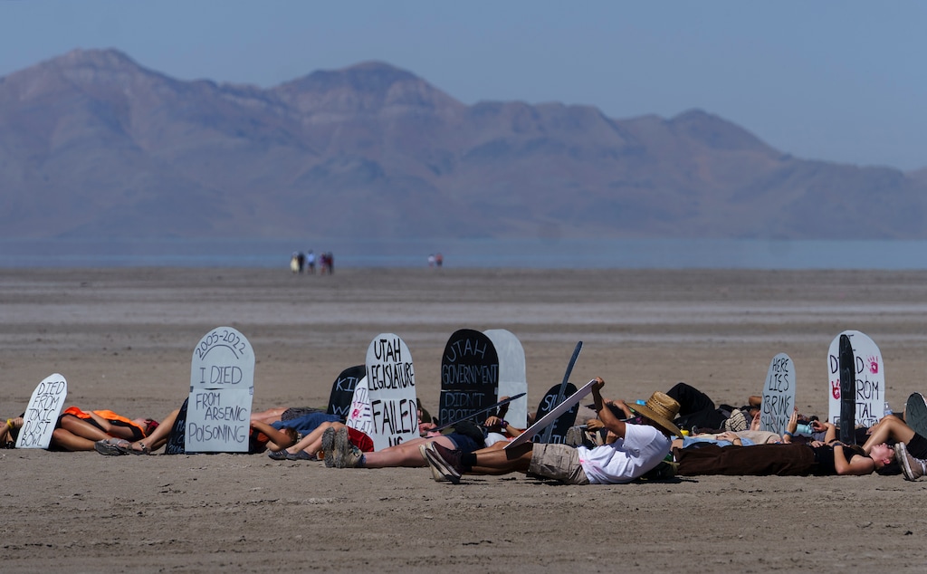(Leah Hogsten | The Salt Lake Tribune) Members of Utah Youth Environmental Solutions Network (UYES) and volunteers stage a "die-in" near Saltair, Sept. 3, 2022, to call for immediate action to protect the Great Salt Lake. The event began with a funeral-like procession on the dry lakebed, where youth organizers gave speeches and called for action from citizens and legislators.