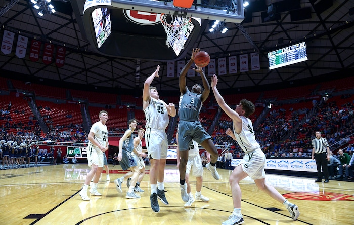 (Leah Hogsten | The Salt Lake Tribune) Corner Canyon's Josh Christensen (03) is fouled under the net by Olympus' Harrison Creer (23). Olympus plays Corner Canyon for the 5A High School BoysÕ Basketball Tournament Championship at the Jon M. Huntsman Center in Salt Lake City, Saturday, March 3, 2018.