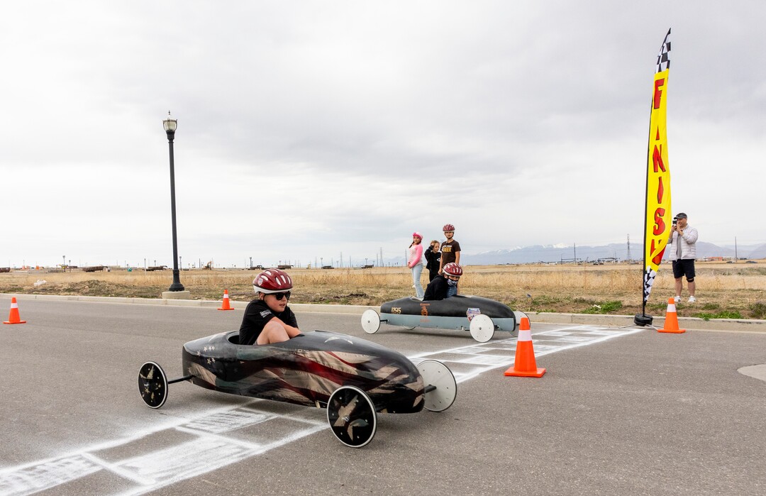 (Rick Egan | The Salt Lake Tribune) Titanium Night Car edges out Neighborhood Church, at the finishline, in the Daybreak Soap Box Derby, on Saturday, April 24, 2021.