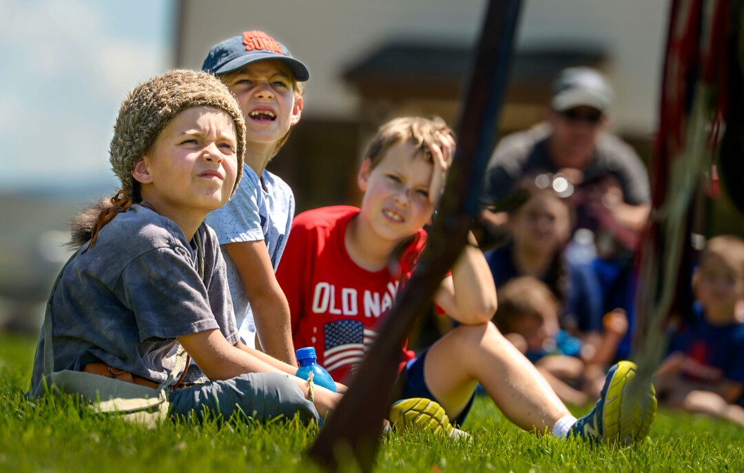 (Leah Hogsten  |  The Salt Lake Tribune) Joey Mortensen, left, and his cousin Gabe Mortenson, center, learn about how to load, clean and fire a flintlock during Pioneer Day festivities at the American West Heritage Center in Wellsville, July 24, 2020.