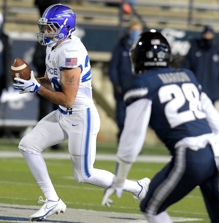 Air Force running back Kadin Remsberg (24) carries the ball for a 21-yard touchdown against Utah State during the first half of an NCAA college football game Thursday, Dec. 3, 2020, in Logan, Utah. (Eli Lucero/The Herald Journal via AP, Pool)