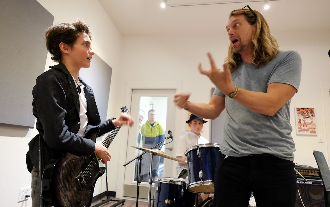 (Francisco Kjolseth  |  The Salt Lake Tribune)  Tega Hamlin, 13, gets a little guidance from Terence Hansen, Music Director at MusicGarage.org in Sugarhouse as kids take a break from rock and roll to learn some blues during a recent jam session.