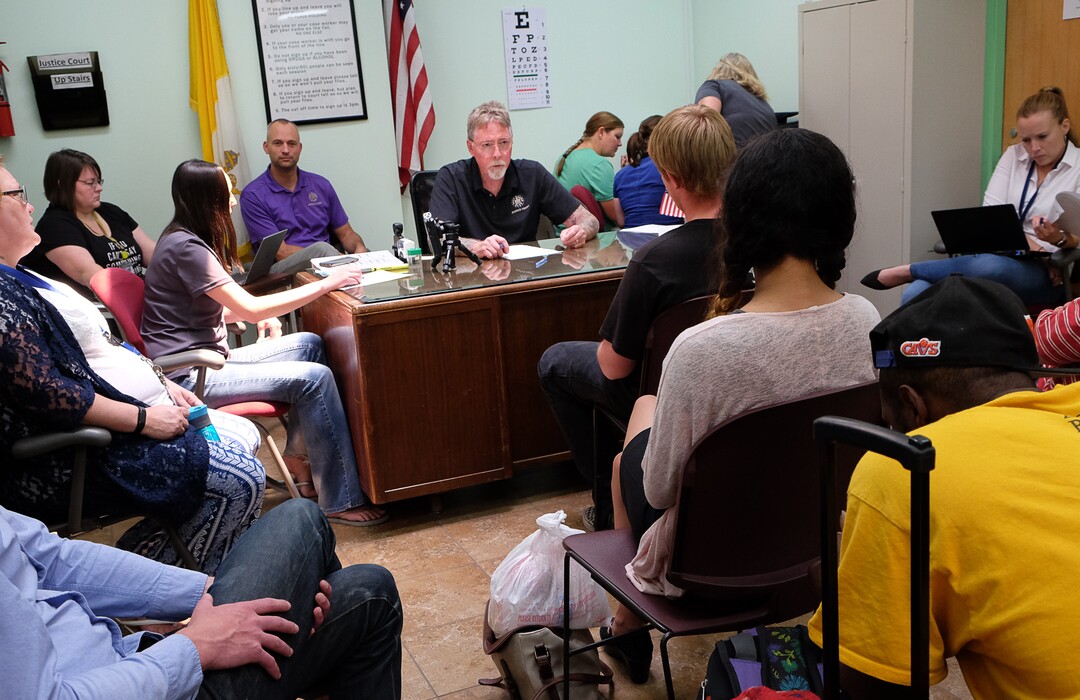 (Francisco Kjolseth  |  The Salt Lake Tribune)  Judge John L. Baxter speaks with a defendant during court held for homeless or transient people in the Weigand Center in Salt Lake City, June 28, 2019. Since May 2004, Salt Lake City has operated a homeless court, where transients can handle misdemeanor charges without showing up in regular court. This helps the homeless person by clearing outstanding warrants they have in a less intimidating environment and it also benefits the regular court by reducing its backlog of such cases. It's part of a larger effort on the part of the American Bar Association to decriminalize homelessness.