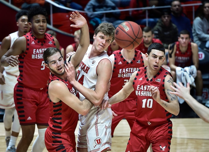 (Scott Sommerdorf   |  The Salt Lake Tribune)   Utah's Jayce Johnson is sandwiched between Eastern Washington defenders as he battles for a rebound during first half play. Utah held a 46-27 lead over Eastern Washington at the half, Friday, November 24, 2017. 