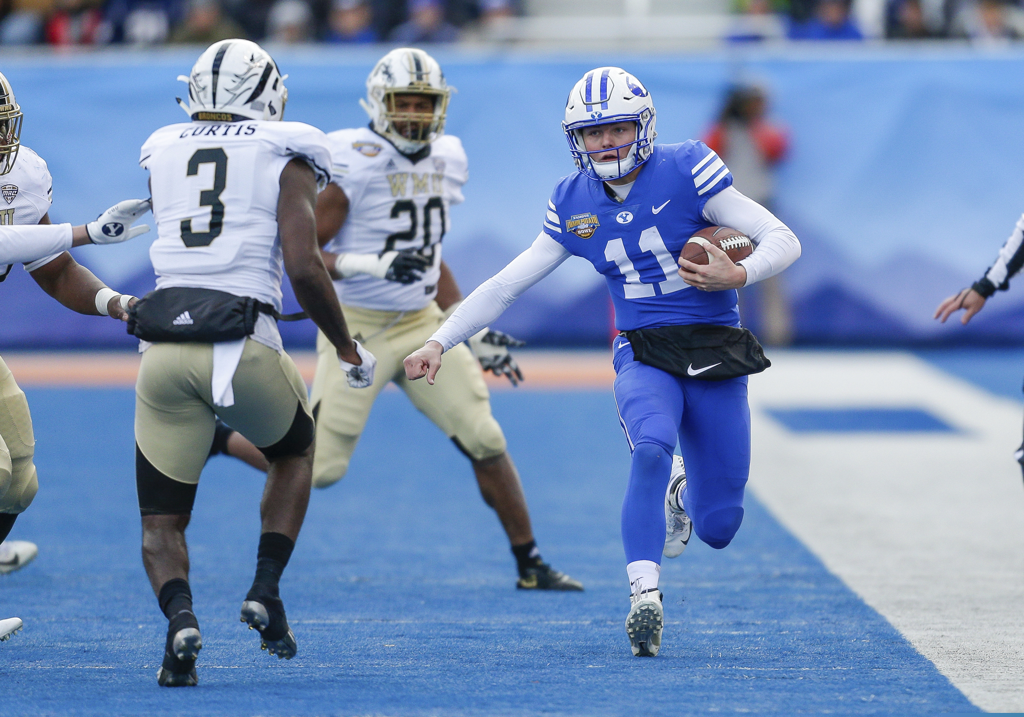 BYU quarterback Zach Wilson (11) runs down the sideline against Western Michigan in the first half of the Famous Idaho Potato Bowl NCAA college football game, Friday, Dec. 21, 2018, in Boise, Idaho. (AP Photo/Steve Conner)