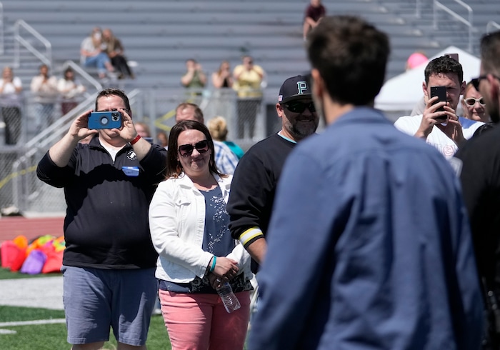 (Bethany Baker | The Salt Lake Tribune) People take photos of Kevin Bacon during a charity event to commemorate the 40th anniversary of the movie "Footloose" on the football field of Payson High School in Payson on Saturday, April 20, 2024.