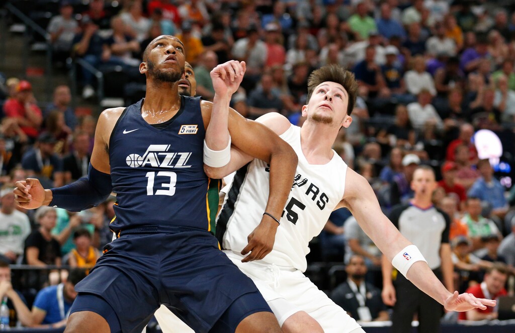 Utah Jazz's Tony Bradley (13) battles under the boards with San Antonio Spurs center Drew Eubanks (25) during the first half of an NBA summer league basketball game Monday, July 2, 2018, in Salt Lake City. (AP Photo/Rick Bowmer)