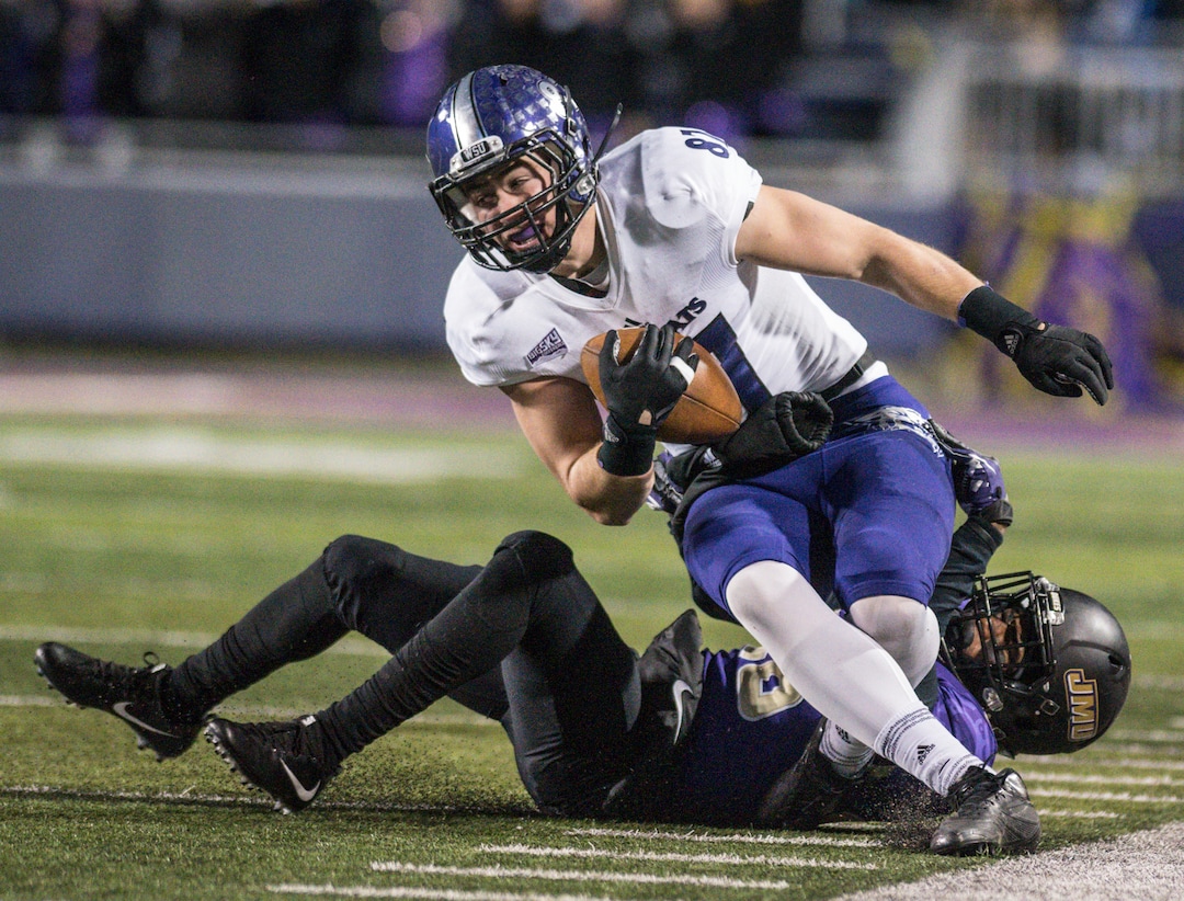 Weber State tight end Andrew Vollert (87) gets brought down by James Madison cornerback Curtis Oliver (26) during the first half of an NCAA college football game in the quarterfinals of the FCS playoffs Friday, Dec. 8, 2017, in Harrisonburg, Va. (Daniel Lin/Daily News-Record via AP)