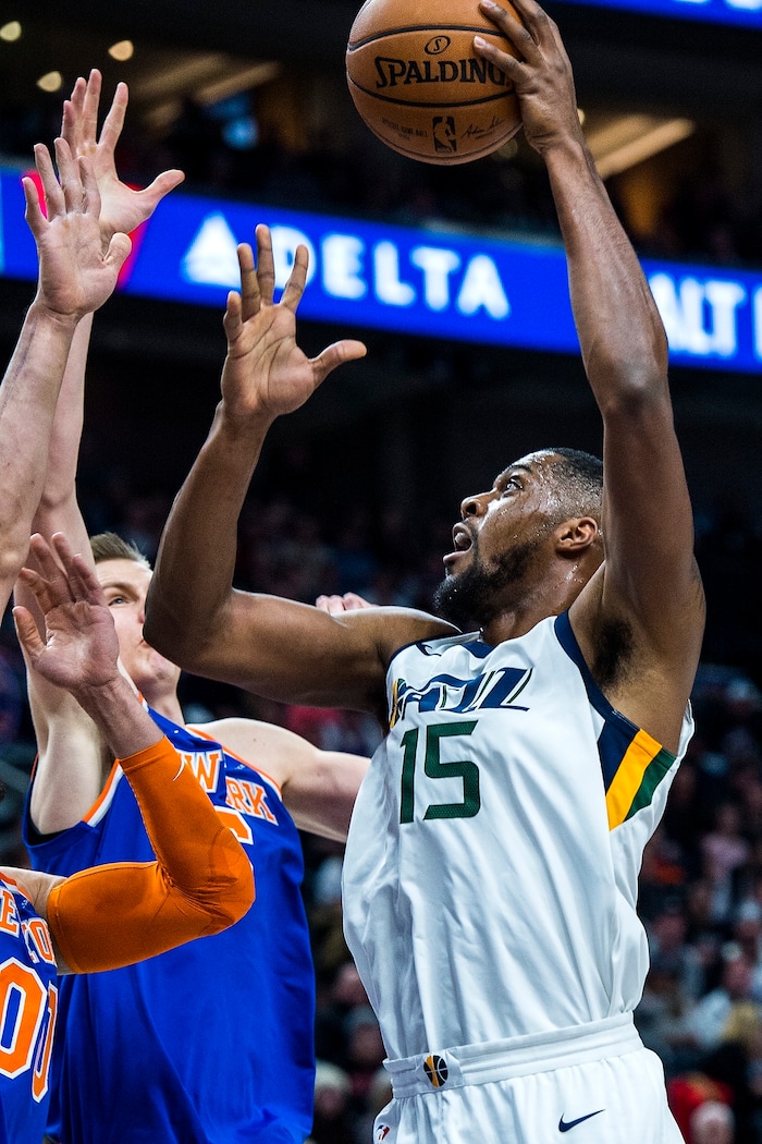 (Chris Detrick  |  The Salt Lake Tribune)  Utah Jazz forward Derrick Favors (15) shoots past New York Knicks forward Kristaps Porzingis (6) during the game at Vivint Smart Home Arena Friday, January 19, 2018.  