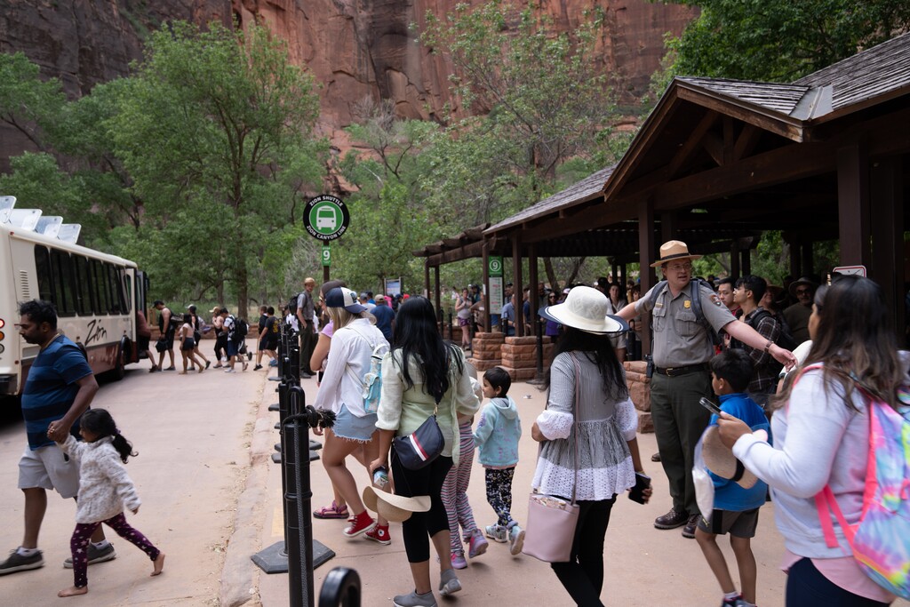 (Jonathan Shafer | NPS) Visitors prepare to board the park shuttle at the Temple of Sinawava shuttle stop in Zion Canyon during the 2022 Memorial Day weekend.