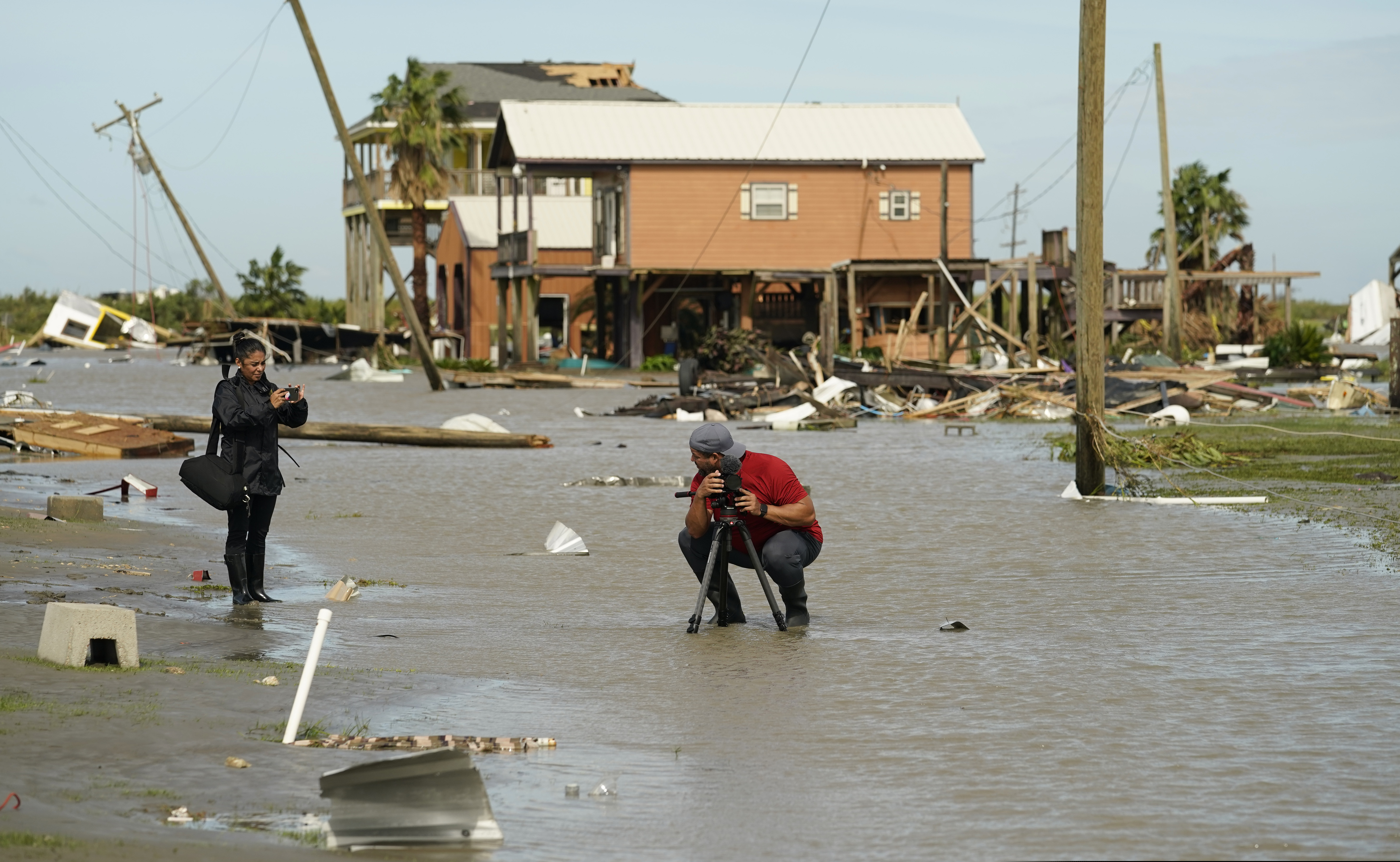 Journalists examine damage left in the wake of Hurricane Laura, Thursday, Aug. 27, 2020, in Holly Beach, La. (AP Photo/Eric Gay)