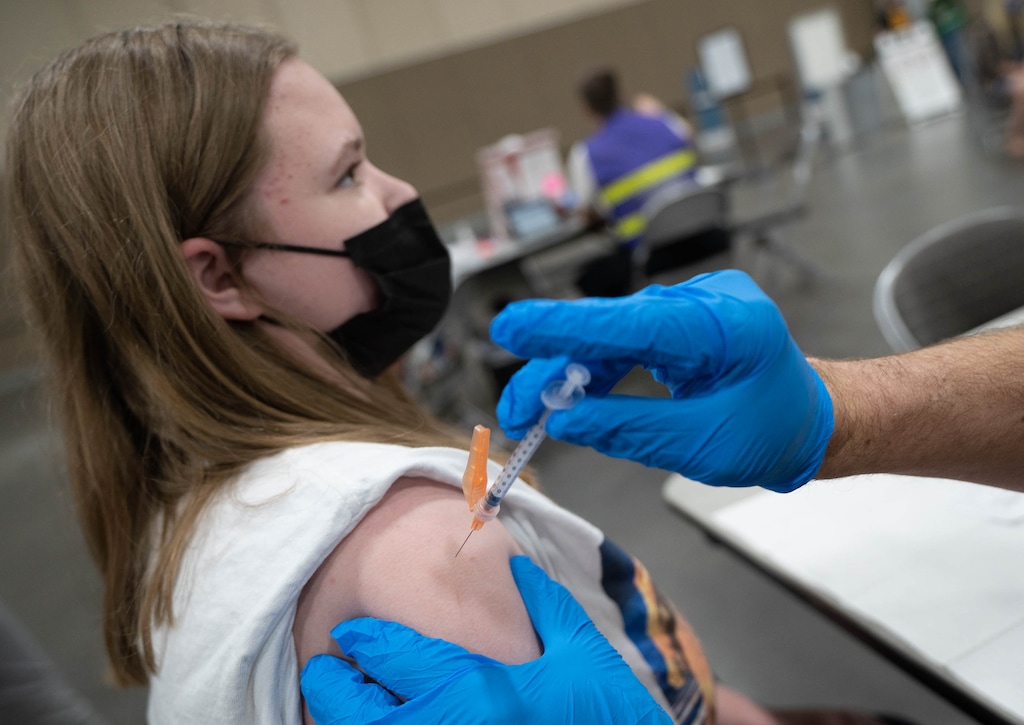(Francisco Kjolseth | The Salt Lake Tribune) Allison Price, 15, receives the Pfizer vaccine as 12- to 15-year-olds were vaccinated against COVID-19 at the Mountain America Expo Center in Sandy on Tuesday, May 18, 2021. Utah pediatricians are urging Utah parents to vaccinate eligible children before they return to school.