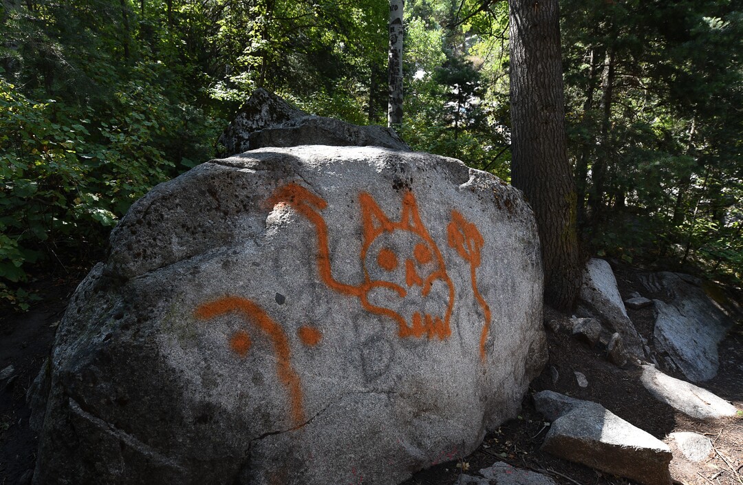 (Francisco Kjolseth  |  The Salt Lake Tribune)  Graffiti has proliferated in lower Little Cottonwood Canyon, where vandals, often wielding cans of fluorescent-colored spray paint, have covered granite faces, trees and structures. The vandalism is particularly apparent along the Temple Quarry Trail and the creek at the Moon Rock swimming hole and former pavilion site. Volunteers using donated equipment and solvents spend thousands of hours removing the paint from the rocks only to see graffiti return to the same faces or on rock nearby.