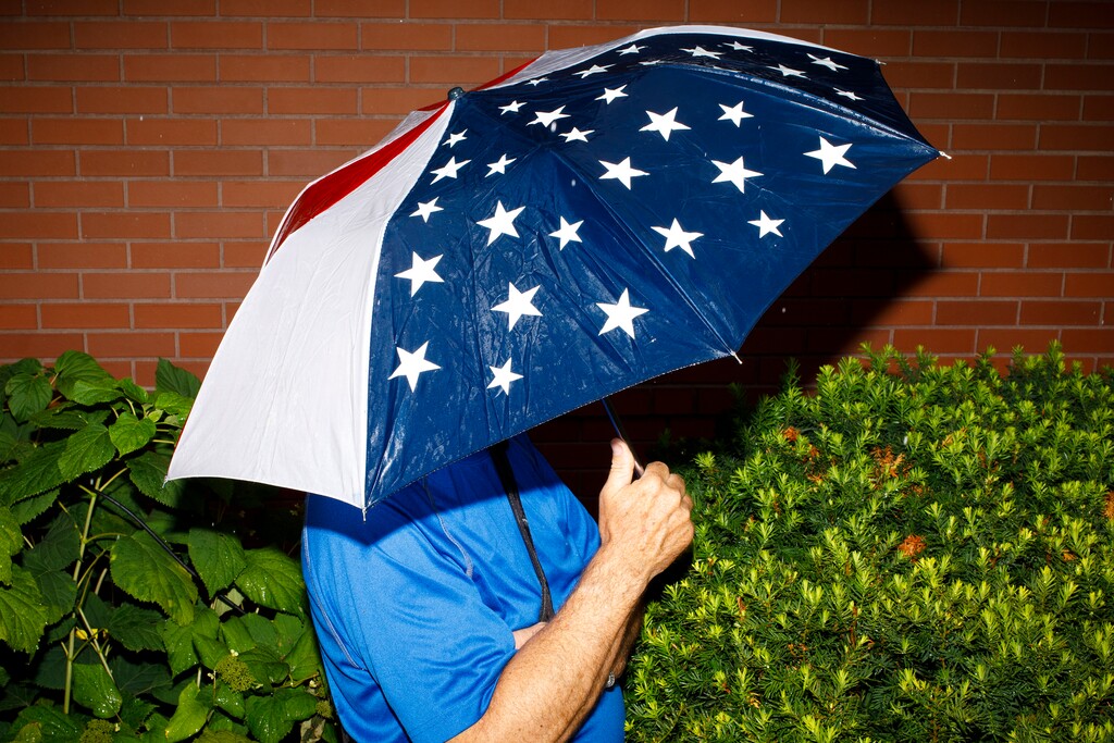(Tom Brenner| The New York Times)

A fairgoer holds an umbrella at the Iowa State Fair in Des Moines, Iowa, Aug. 11, 2019. "Today, what remains of conservative intelligentsia is split," writes New York Times columnist Bret Stephens.