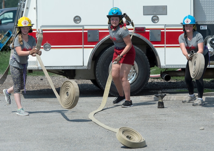 (Rick Egan  |  The Salt Lake Tribune)  Rylee, Shelby and Clarissa roll out firehoses while competing in a fire fighter skills relay, while attending Camp Fury.  A dozen Utah Girl Scouts participated in a 3-day camp led by female firefighters. Camp Fury Utah was developed in partnership with the Girl Scouts and local fire and police departments, designed to expose teen girls to careers in public safety and other non-traditional jobs. Saturday, August 5, 2017.


