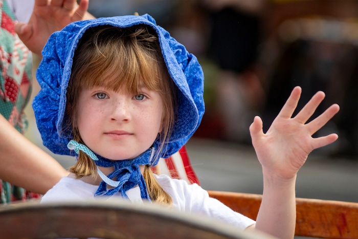 (Rick Egan | The Salt Lake Tribune) Millie Westenskow waves to the crowd while riding in a handcart in the Days of '47 Parade in Salt Lake City on Thursday, July 24, 2025.