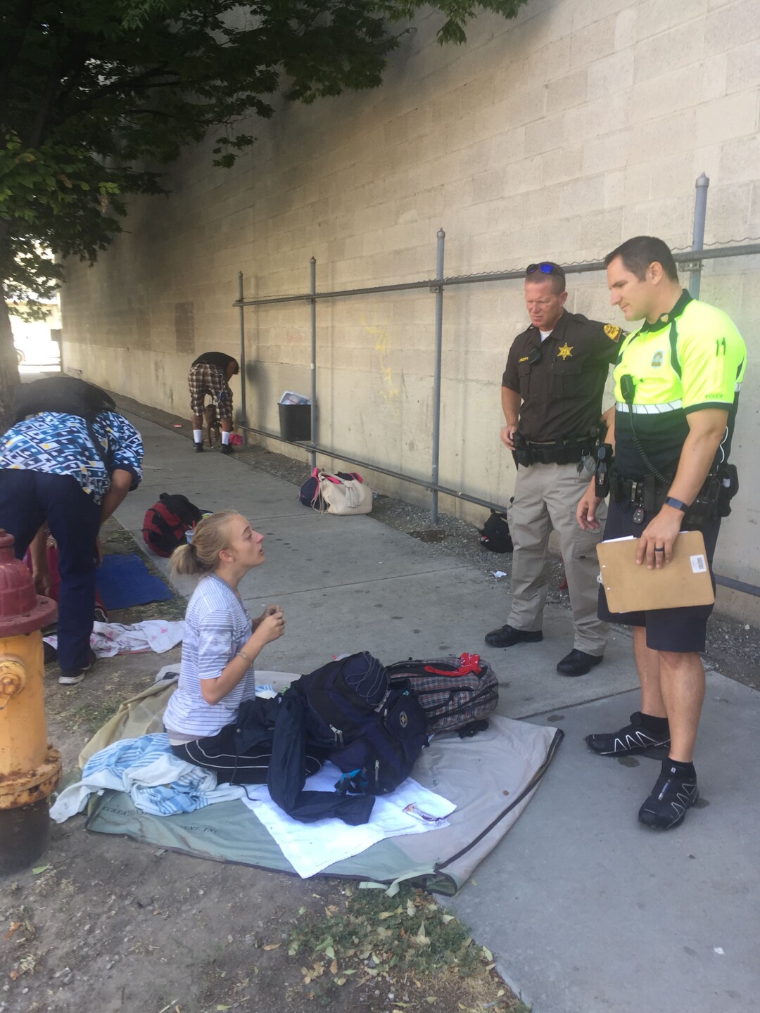 (Christopher Smart  |  The Salt Lake Tribune)  Salt Lake City police Sgt. Sam Wolf talks to an 18-year-old heroin addict on 500 West on Monday morning, August 14, 2017. She declined his offer for help.