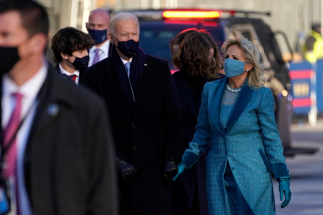President Joe Biden walks with first lady Jill Biden during the Presidential Escort, part of Inauguration Day ceremonies, Wednesday, Jan. 20, 2021, in Washington. (AP Photo/Evan Vucci)
