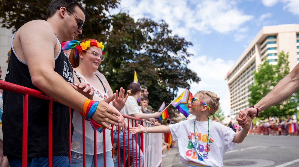 (Rick Egan | The Salt Lake Tribune) A young girl greets people at the Pride Parade, on Sunday, June 2, 2024.