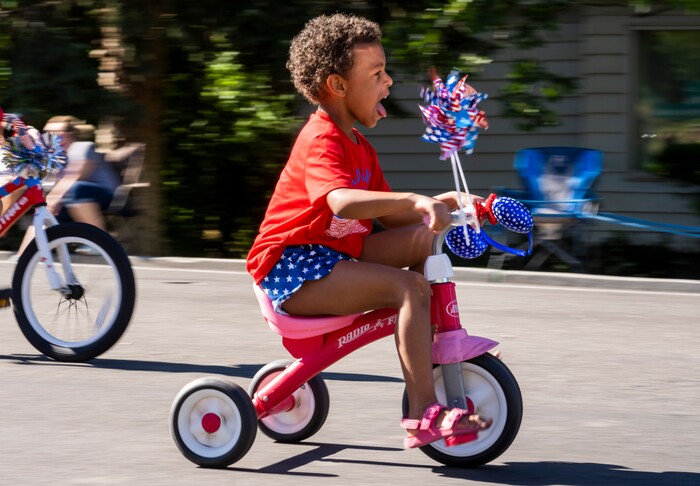 (Rick Egan | The Salt Lake Tribune) A young child rides  in the Kids Bike parade, during the Cherry Days Fourth of July Celebration, in North Ogden, on Monday, July 4, 2022.