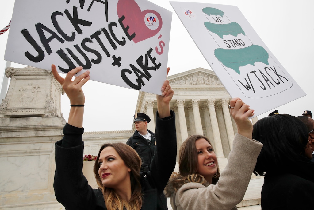 Janae Stracke, left, and Annabelle Rutledge, both with Concerned Women for America, hold up signs in support of cake artist Jack Phillips outside of the Supreme Court which is hearing the 'Masterpiece Cakeshop v. Colorado Civil Rights Commission,' Tuesday, Dec. 5, 2017, in Washington. (AP Photo/Jacquelyn Martin)
