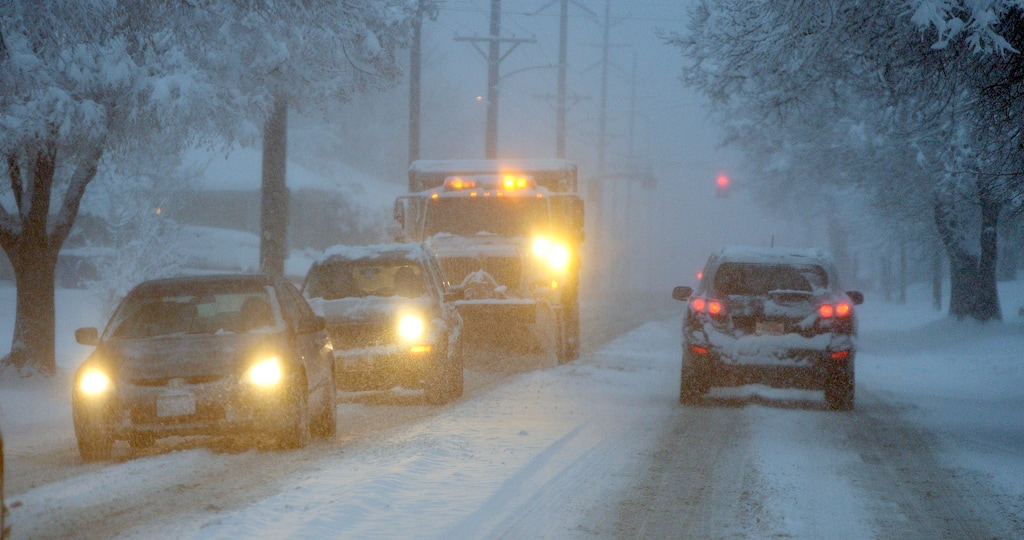 (Al Hartmann | Tribune file photo)  Salt Lake City residents commute during snowfall in this file photo. One Utahn has created a Change.org petition asking lawmakers to get roads repainted with reflective paint so lanes can be seen during bad weather and at night.